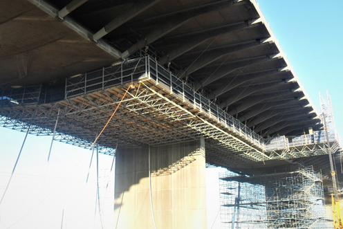 Suspended access platforms and decking for transport infrastructure.