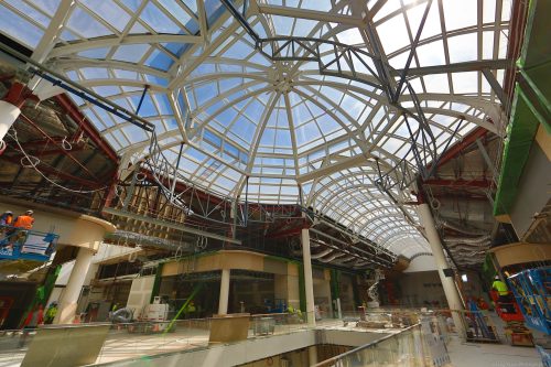 A shopping centre domed skylight with metal beams as support.
